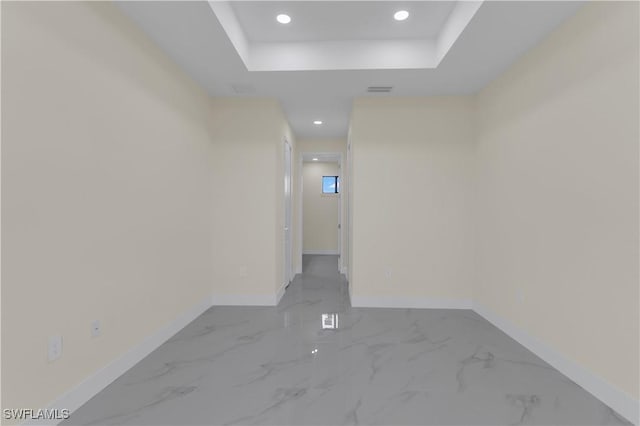 3307 18th St SW, Lehigh Acres, FL 33976 - empty room featuring marble look tiles, a tray ceiling, and recessed lighting