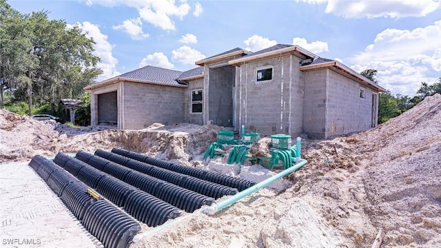 615 8th Ave, Lehigh Acres, FL 33972 - view of property exterior with concrete block siding and an attached garage