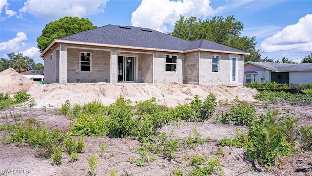 615 8th Ave, Lehigh Acres, FL 33972 - rear view of property featuring concrete block siding and a shingled roof