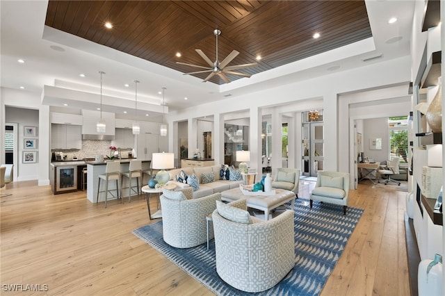 745 Riviera Dr, Naples, FL 34103 - living area featuring a raised ceiling, wine cooler, light wood finished floors, wood ceiling, and a ceiling fan