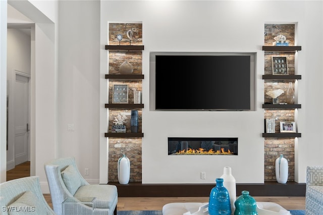 745 Riviera Dr, Naples, FL 34103 - living area with a glass covered fireplace and wood finished floors