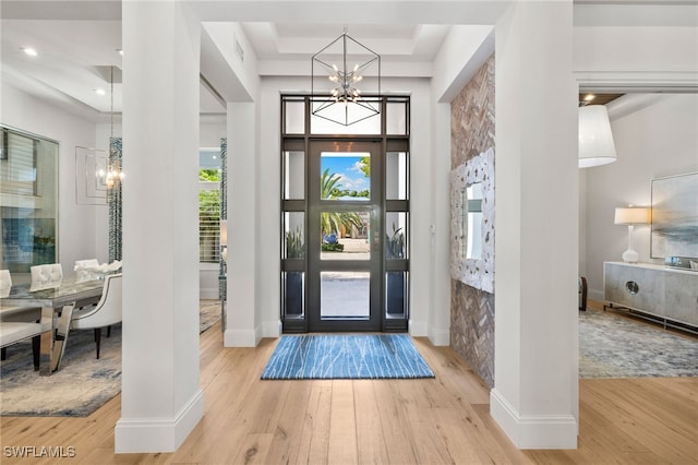 745 Riviera Dr, Naples, FL 34103 - entryway featuring a chandelier, hardwood / wood-style flooring, a raised ceiling, and recessed lighting