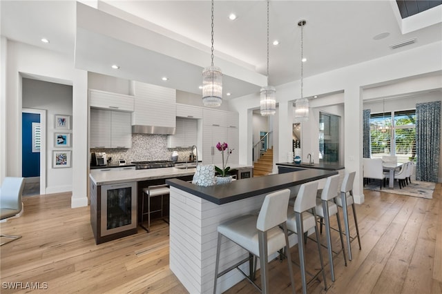 745 Riviera Dr, Naples, FL 34103 - kitchen featuring a spacious island, light wood-style flooring, modern cabinets, backsplash, and recessed lighting