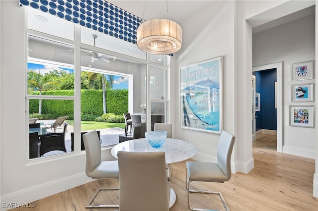 745 Riviera Dr, Naples, FL 34103 - dining room featuring wood finished floors and a towering ceiling