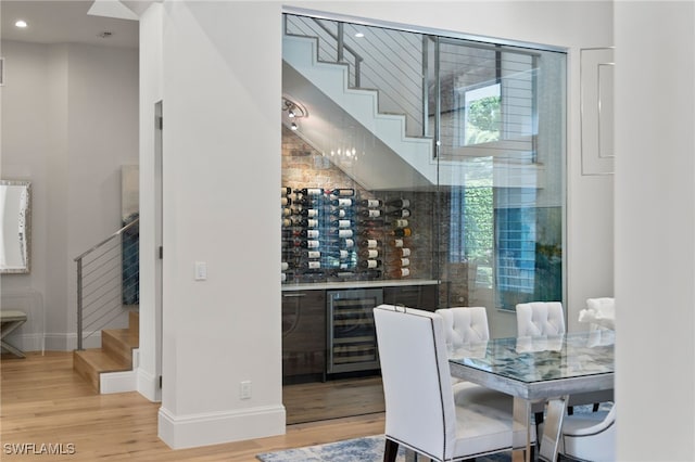 745 Riviera Dr, Naples, FL 34103 - wine area featuring beverage cooler, wood finished floors, and recessed lighting