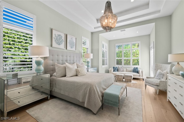 745 Riviera Dr, Naples, FL 34103 - bedroom featuring light wood-type flooring, a tray ceiling, recessed lighting, and a chandelier