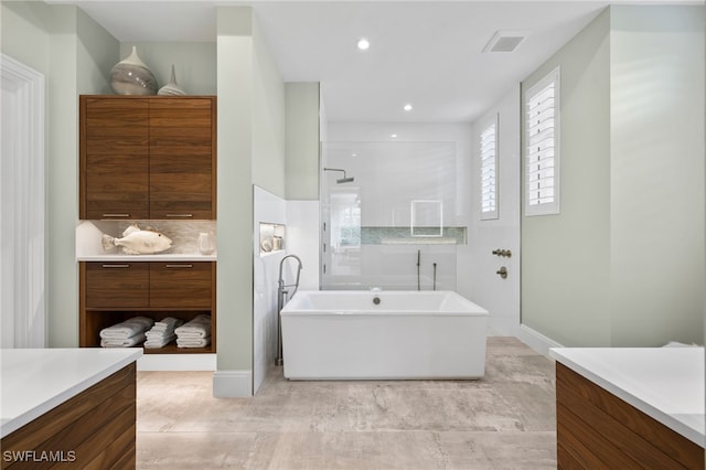 745 Riviera Dr, Naples, FL 34103 - full bath featuring vanity, a freestanding tub, walk in shower, and recessed lighting