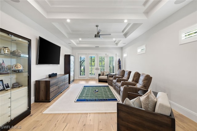 745 Riviera Dr, Naples, FL 34103 - living area with a ceiling fan, a tray ceiling, healthy amount of natural light, and light wood-type flooring