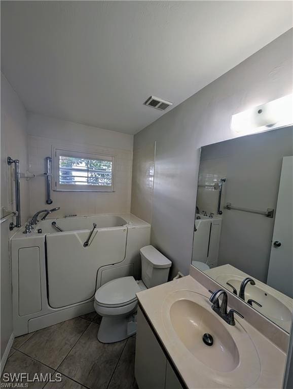 1915 Courtyard Way Unit G102, Naples, FL 34112 - full bathroom with a garden tub, vanity, and tile patterned flooring