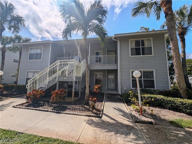1915 Courtyard Way Unit G102, Naples, FL 34112 - view of front facade featuring stairway and covered porch