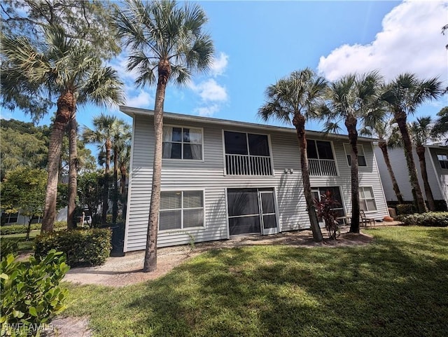 1915 Courtyard Way Unit G102, Naples, FL 34112 - rear view of house featuring a lawn
