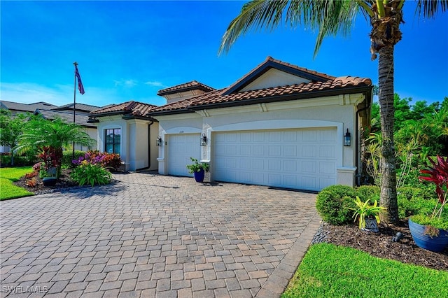 2110 Antigua Ln, Naples, FL 34120 - mediterranean / spanish house with decorative driveway, a garage, stucco siding, and a tiled roof