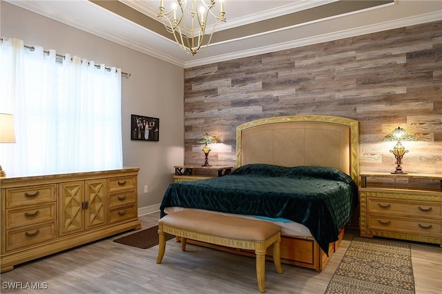 2110 Antigua Ln, Naples, FL 34120 - bedroom featuring a chandelier, wooden walls, light wood finished floors, crown molding, and an accent wall