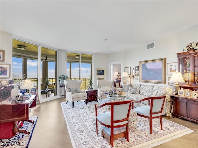 1001 Arbor Lake Dr Unit 1102, Naples, FL 34110 - living area featuring wood finished floors and a wall of windows
