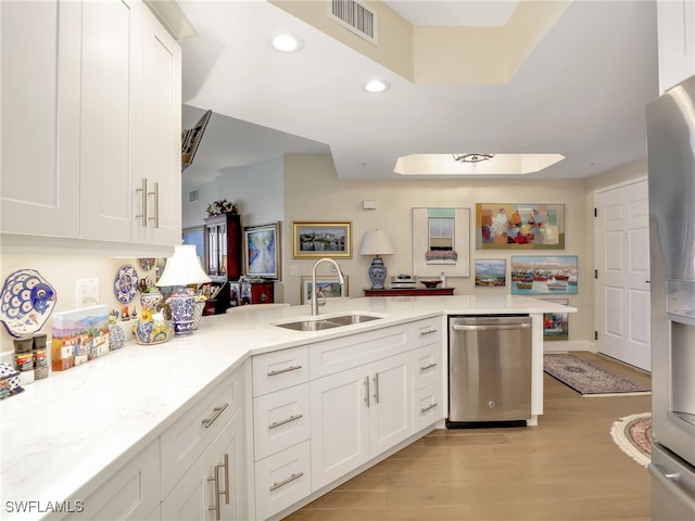1001 Arbor Lake Dr Unit 1102, Naples, FL 34110 - kitchen with appliances with stainless steel finishes, light wood-style floors, white cabinets, recessed lighting, and a peninsula