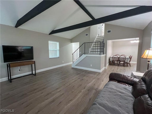 195 E Mariana Ave, North Fort Myers, FL 33917 - living area featuring beam ceiling, stairs, wood finished floors, a chandelier, and high vaulted ceiling