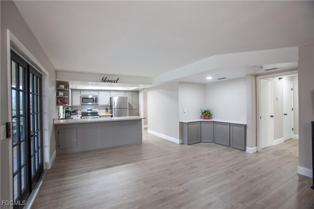 195 E Mariana Ave, North Fort Myers, FL 33917 - kitchen with gray cabinets, stainless steel appliances, light wood-style flooring, a peninsula, and recessed lighting
