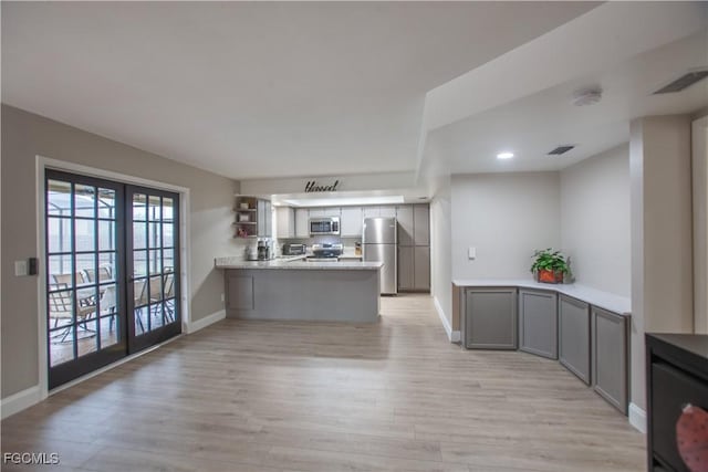 195 E Mariana Ave, North Fort Myers, FL 33917 - kitchen featuring a peninsula, stainless steel appliances, light wood-style flooring, light countertops, and recessed lighting