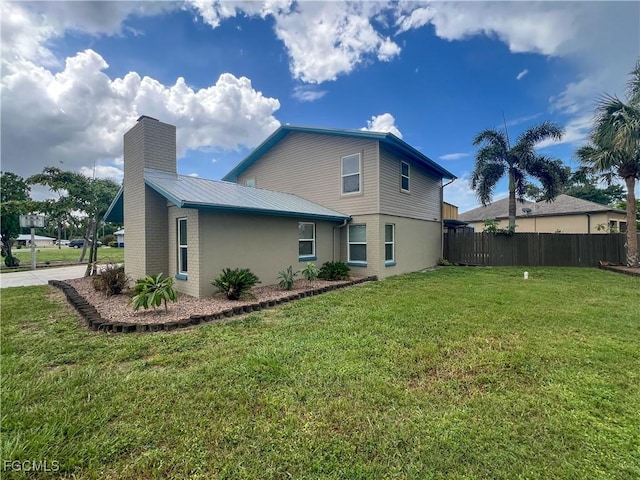 195 E Mariana Ave, North Fort Myers, FL 33917 - rear view of house featuring a metal roof and a chimney