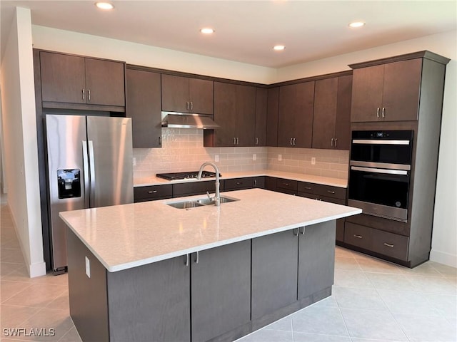 16381 Preservation Blvd, Punta Gorda, FL 33982 - kitchen with appliances with stainless steel finishes, under cabinet range hood, light tile patterned flooring, dark brown cabinets, and recessed lighting