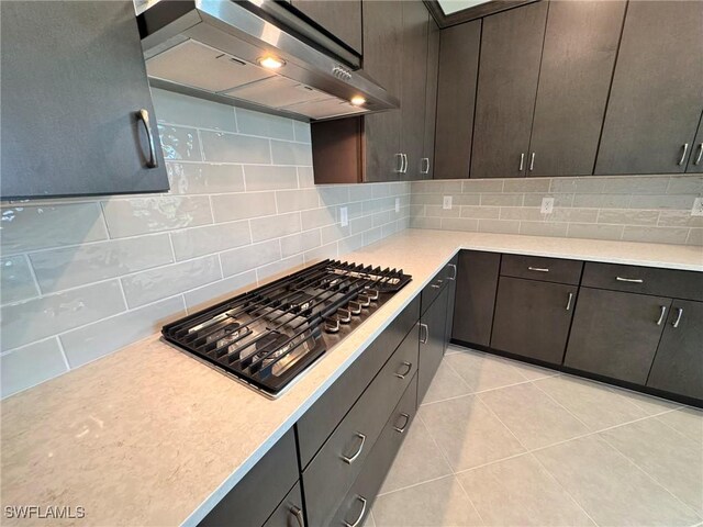 16381 Preservation Blvd, Punta Gorda, FL 33982 - kitchen featuring ventilation hood, stainless steel gas cooktop, light countertops, and tasteful backsplash