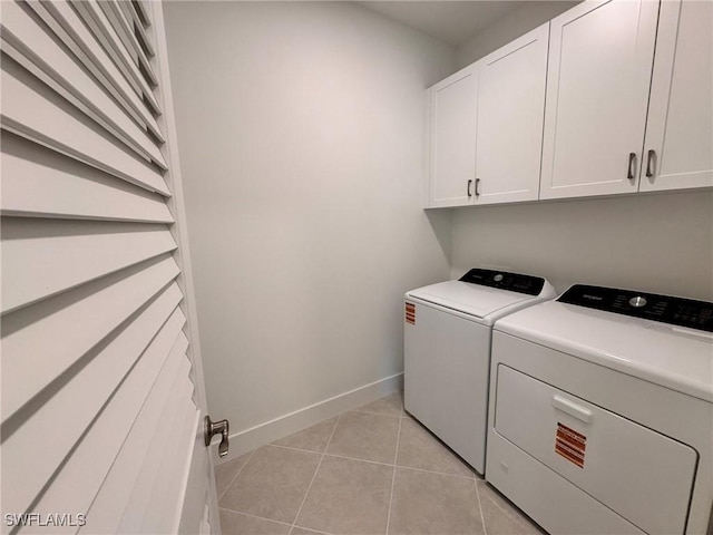 16381 Preservation Blvd, Punta Gorda, FL 33982 - laundry room featuring washing machine and dryer, cabinet space, and light tile patterned flooring