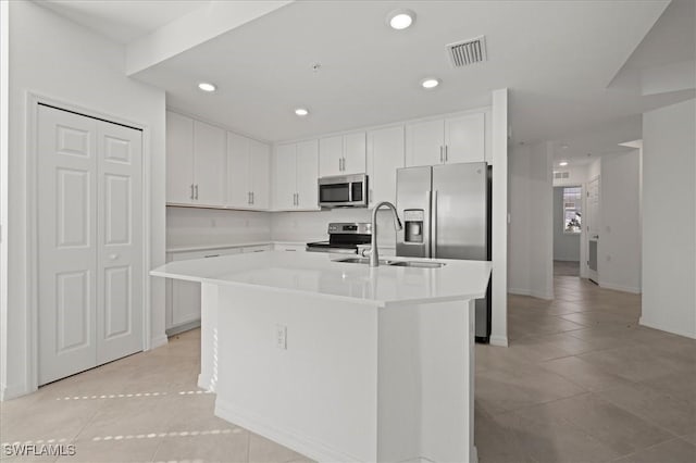 43993 Boardwalk Loop Unit 1918, Punta Gorda, FL 33982 - kitchen featuring appliances with stainless steel finishes, light tile patterned floors, white cabinetry, light countertops, and an island with sink