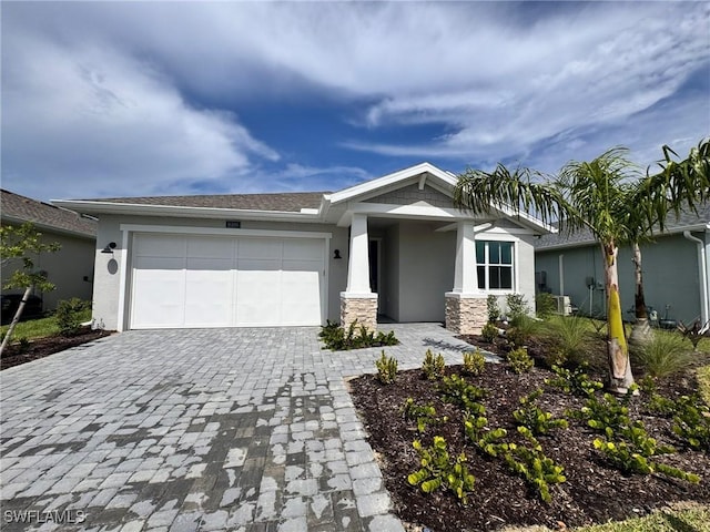 16106 Preservation Blvd, Punta Gorda, FL 33982 - view of front of house featuring stucco siding, an attached garage, and decorative driveway