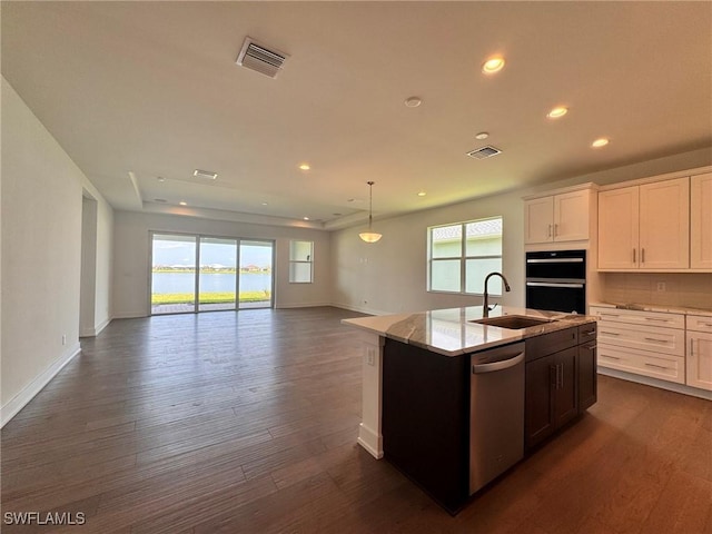 16106 Preservation Blvd, Punta Gorda, FL 33982 - kitchen with stainless steel dishwasher, recessed lighting, a center island with sink, open floor plan, and dark wood-style floors