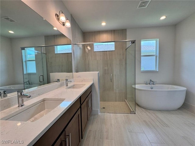 16106 Preservation Blvd, Punta Gorda, FL 33982 - bathroom with double vanity, a soaking tub, plenty of natural light, a shower stall, and recessed lighting