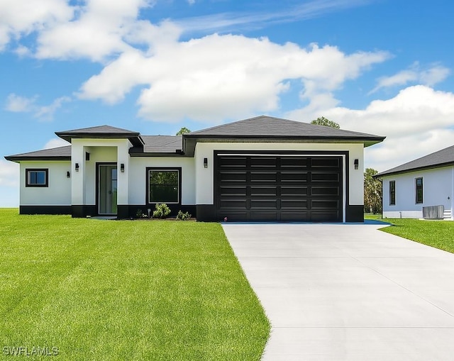 3301 8th St SW, Lehigh Acres, FL 33976 - prairie-style home with stucco siding, driveway, a garage, and a front lawn