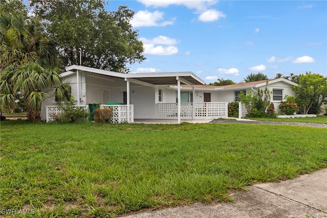 138 Dowling Ave NE, Port Charlotte, FL 33952 - view of front of property featuring a front yard, an attached carport, and driveway