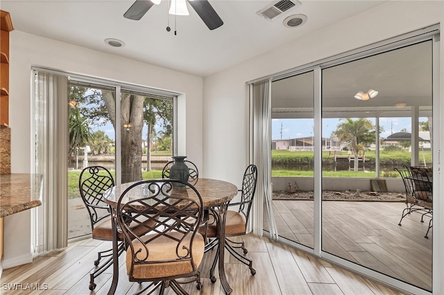 138 Dowling Ave NE, Port Charlotte, FL 33952 - dining room featuring ceiling fan and light wood-type flooring
