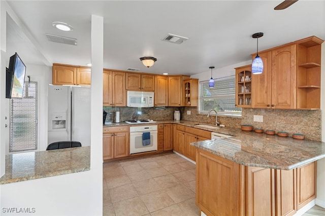 138 Dowling Ave NE, Port Charlotte, FL 33952 - kitchen featuring white appliances, open shelves, light stone countertops, a peninsula, and decorative light fixtures