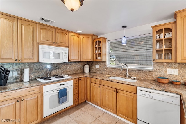 138 Dowling Ave NE, Port Charlotte, FL 33952 - kitchen featuring white appliances, light stone countertops, backsplash, light tile patterned flooring, and glass insert cabinets