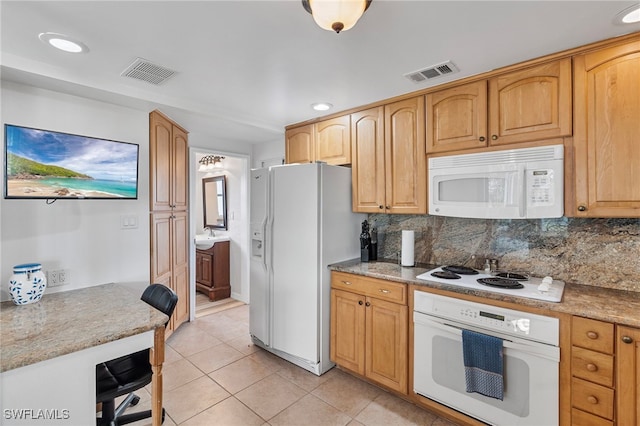 138 Dowling Ave NE, Port Charlotte, FL 33952 - kitchen with white appliances, tasteful backsplash, light tile patterned floors, and recessed lighting
