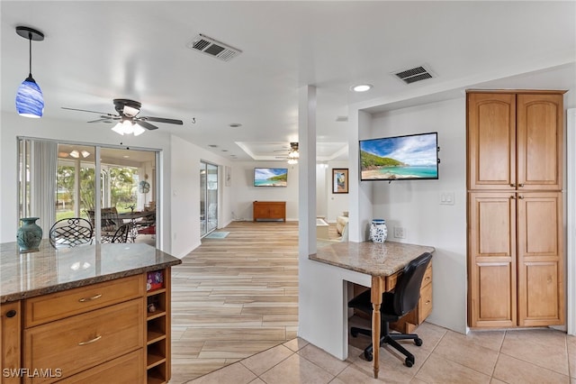 138 Dowling Ave NE, Port Charlotte, FL 33952 - kitchen featuring ceiling fan, stone countertops, a desk, light tile patterned floors, and recessed lighting