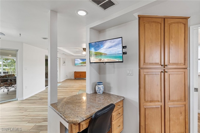 138 Dowling Ave NE, Port Charlotte, FL 33952 - kitchen with a ceiling fan, light wood-style floors, light stone countertops, and open floor plan