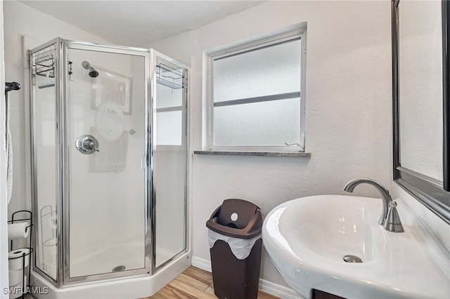 138 Dowling Ave NE, Port Charlotte, FL 33952 - full bath featuring a stall shower and wood finished floors