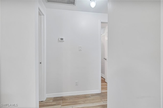 138 Dowling Ave NE, Port Charlotte, FL 33952 - hallway with baseboards and light wood-style flooring