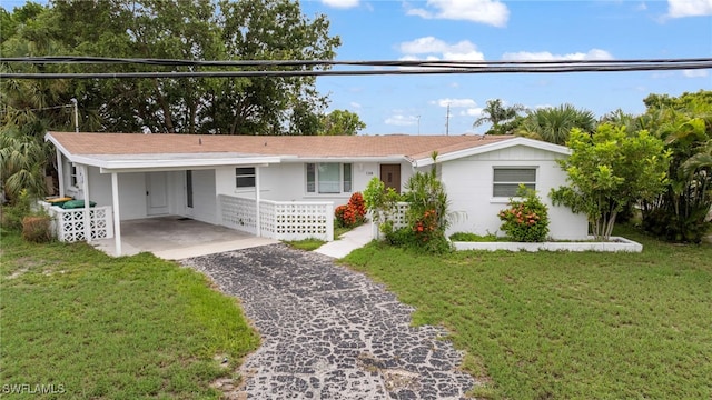 138 Dowling Ave NE, Port Charlotte, FL 33952 - ranch-style house with driveway, a carport, and a front yard