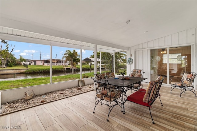 138 Dowling Ave NE, Port Charlotte, FL 33952 - sunroom with a water view, outdoor dining area, and healthy amount of natural light