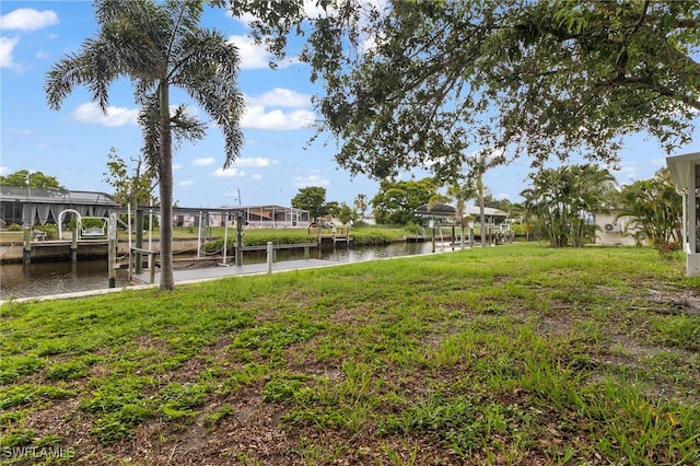 138 Dowling Ave NE, Port Charlotte, FL 33952 - view of yard featuring a water view, a dock, and boat lift
