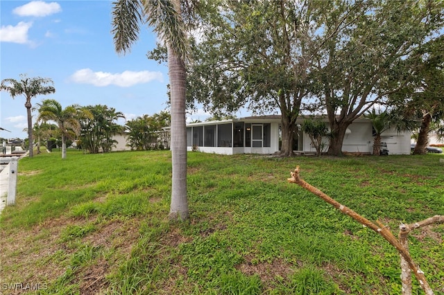 138 Dowling Ave NE, Port Charlotte, FL 33952 - view of green lawn with a sunroom