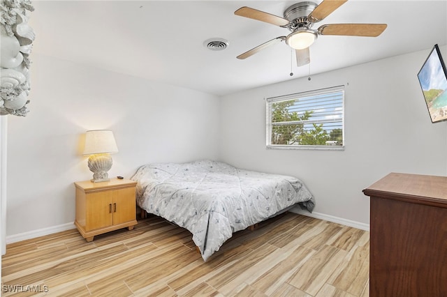 138 Dowling Ave NE, Port Charlotte, FL 33952 - bedroom with light wood-style floors and ceiling fan
