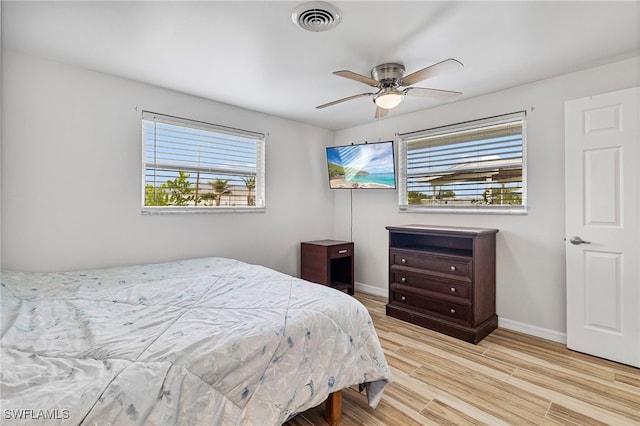 138 Dowling Ave NE, Port Charlotte, FL 33952 - bedroom featuring wood finished floors and a ceiling fan