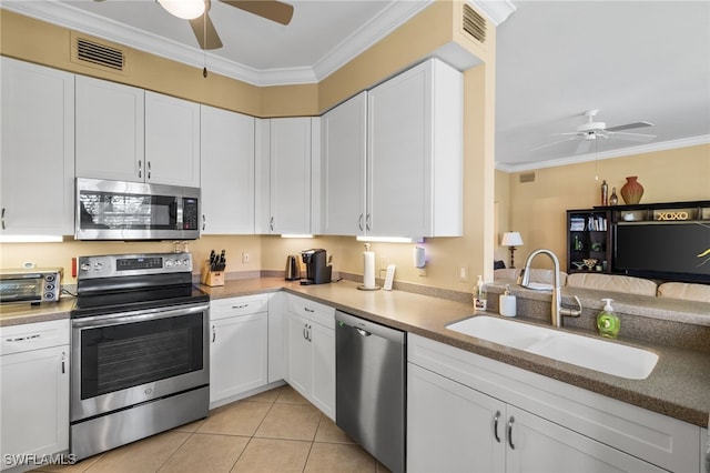 3904 Forest Glen Blvd Unit 102, Naples, FL 34114 - kitchen with appliances with stainless steel finishes, a ceiling fan, ornamental molding, and white cabinetry