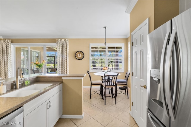 3904 Forest Glen Blvd Unit 102, Naples, FL 34114 - kitchen with appliances with stainless steel finishes, crown molding, light tile patterned floors, white cabinets, and hanging light fixtures