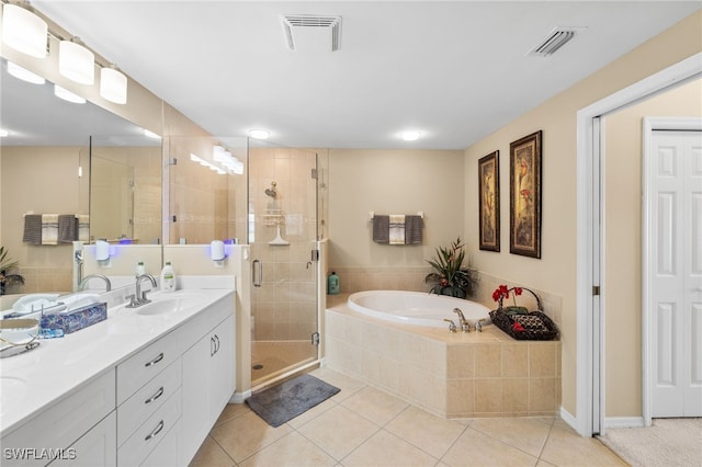 3904 Forest Glen Blvd Unit 102, Naples, FL 34114 - full bath with double vanity, a garden tub, a shower stall, and tile patterned floors