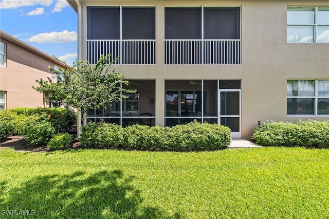 3904 Forest Glen Blvd Unit 102, Naples, FL 34114 - back of house with stucco siding and a lawn